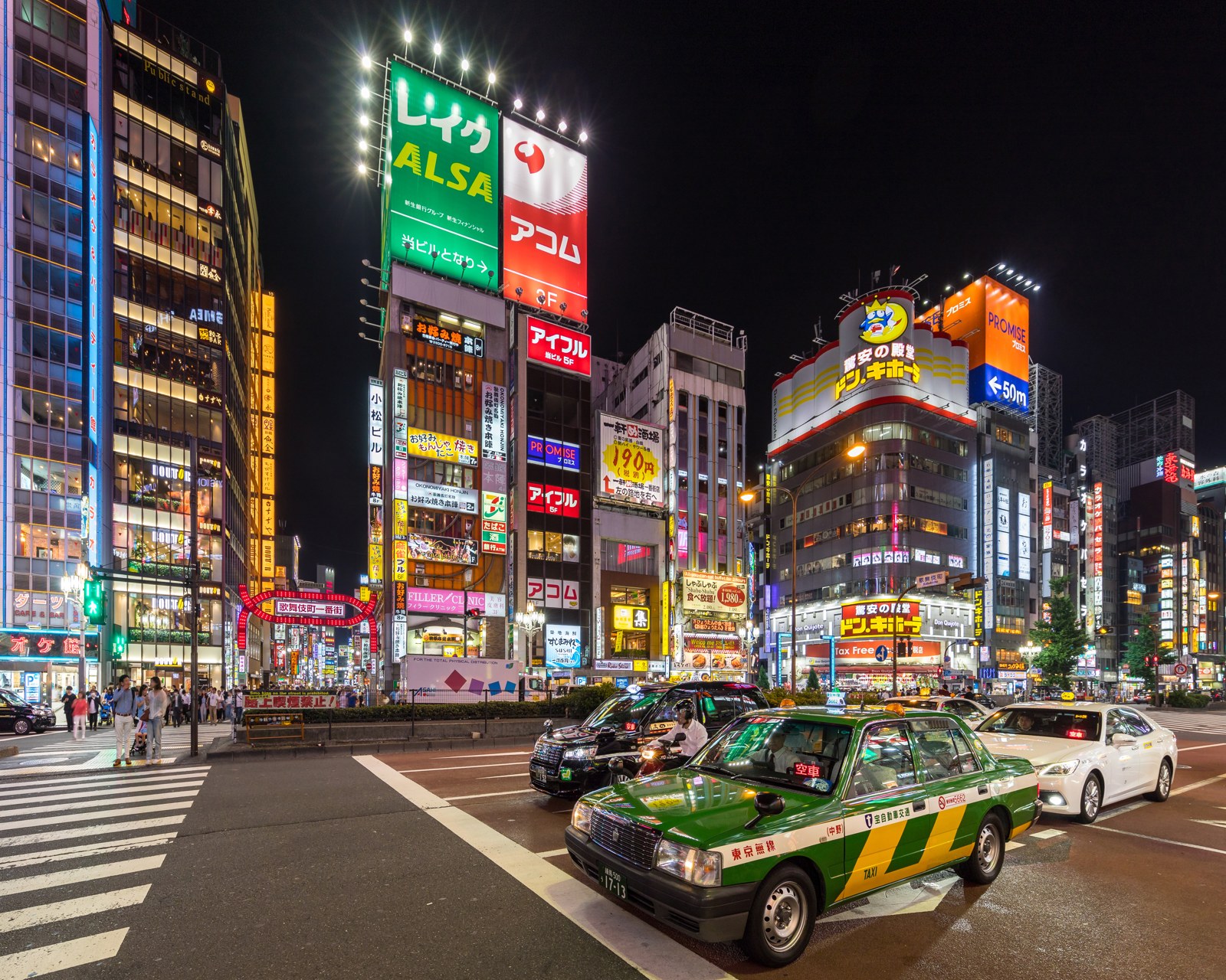 Yasukuni-dori in Shinjuku, Tokyo, with illuminated signs and traffic at night